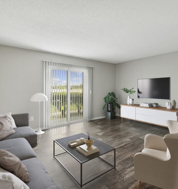 Model Living Room with Wood-Style Flooring at Heron Walk Apartments in Jacksonville, FL-WELCOME.