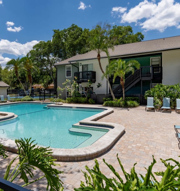 Swimming pool and sundeck at Seven Lakes at Carrollwood Apartments in Tampa, Florida