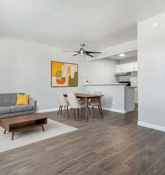 Model Living Room & Kitchen with Wood-Style Flooring at Accent on Rainbow Apartments located in Las Vegas, Nevada.