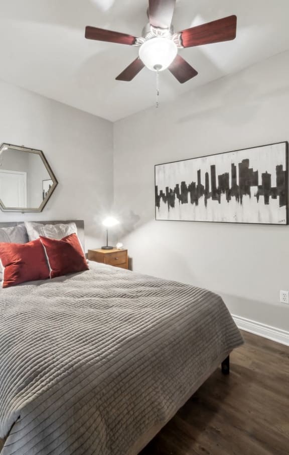 a bedroom with a bed and a ceiling fan