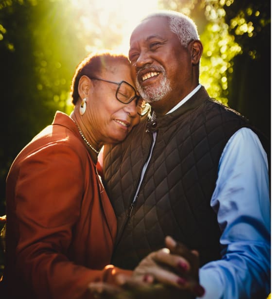 a man and a woman smiling and holding hands