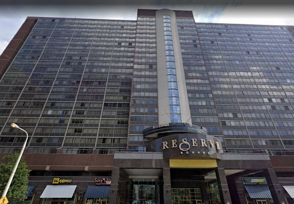 A tall building with a glass facade and a sign that says "Regency".