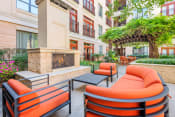 Thumbnail 6 of 12 - Lofts at Lakeview Apartments - Outdoor fireplace with seating