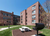 Thumbnail 3 of 15 - Harbor Hill Apartments exterior outdoor grilling