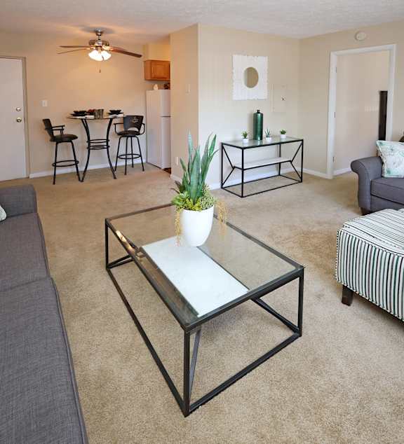 A modern kitchen with a dining table and chairs in the middle of the room.
