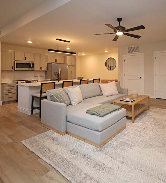 A modern kitchen with a dining table and chairs in the middle of the room.