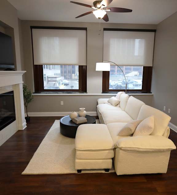 A modern kitchen with a dining table and chairs in the middle of the room.