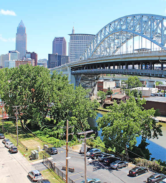 A cityscape with a bridge and a river.