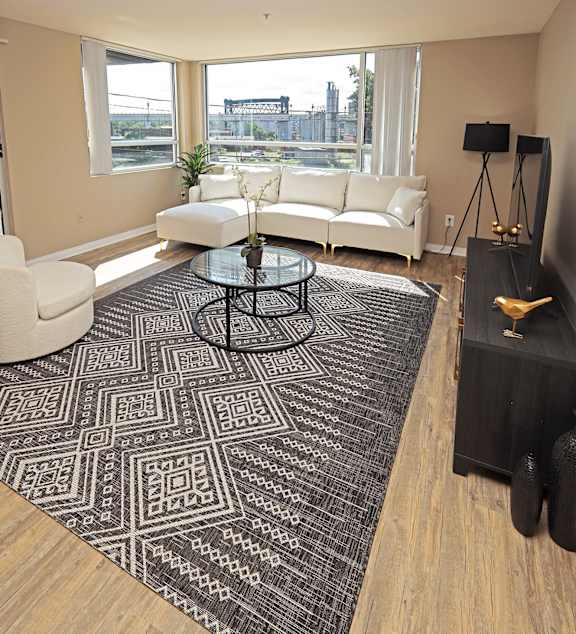 A modern kitchen with a dining table and chairs in the middle of the room.