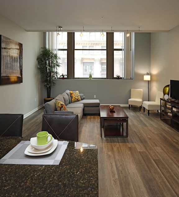 A modern kitchen with a dining table and chairs in the middle of the room.