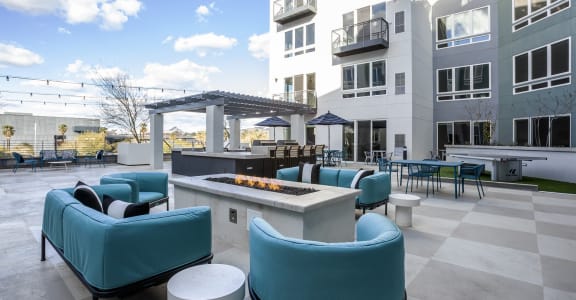 a rooftop patio with chairs and tables and a pergola at Circa Central Avenue in Phoenix, AZ