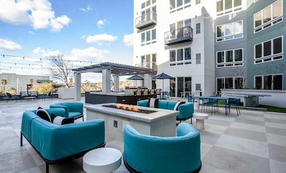 an outdoor lounge area with a fire pit and chairs at Circa Central Avenue in Phoenix, AZ