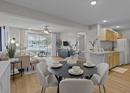 A modern dining room with a table set for four.