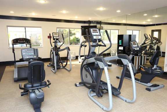 a gym with various exercise equipment in a large room