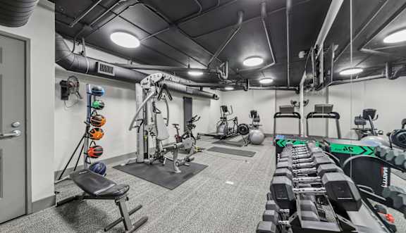 Resident fitness center with cardio equipment at River 595 Apartments