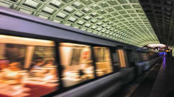 A train is passing through a tunnel with a green ceiling at Argent Apartments, Silver Spring, 20910
