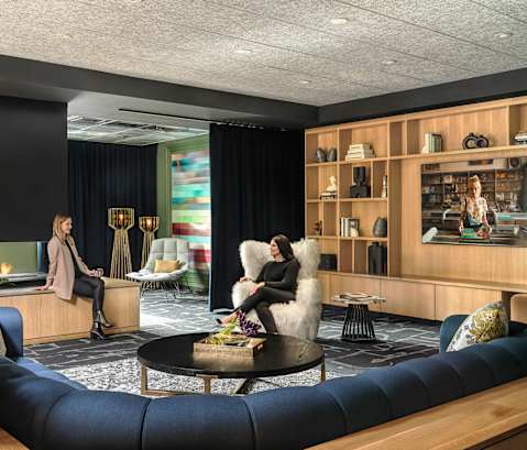 Two women sitting in a modern lounge area.