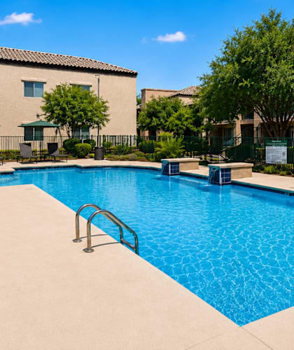 A large swimming pool with a metal ladder in the middle.