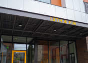 Thumbnail 21 of 23 - the front of a building with a yellow door