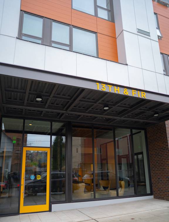 the front of a building with a yellow door