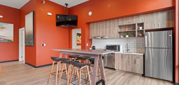 a kitchen with a table and chairs and a refrigerator