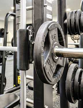VUE 19 (Fitness Center) -gym with a squat rack, bench, and weights.