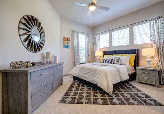 a bedroom with a bed and a ceiling fan