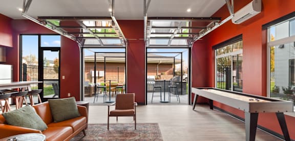 a living room with red walls and a pool table