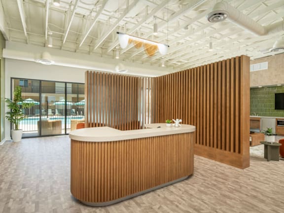 A reception area with a white counter and a brown striped wall.