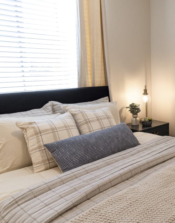 Comfy Guest Bedroom at Four Seasons Apartments in Logan Utah