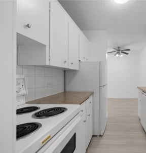 a white kitchen with white appliances and white cabinets