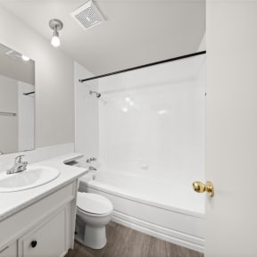 a bathroom with a sink toilet and a tub