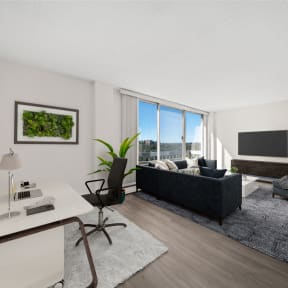 a kitchen and living room with a table and a tv