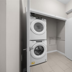 a white washer and dryer in a laundry room with a white door