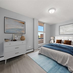 a bedroom with a bed and a window