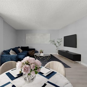 a living room with a table with a vase of flowers on it