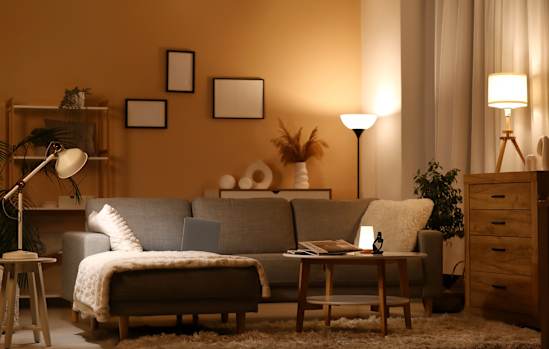 a living room with a white couch and three black and white photos on the wall