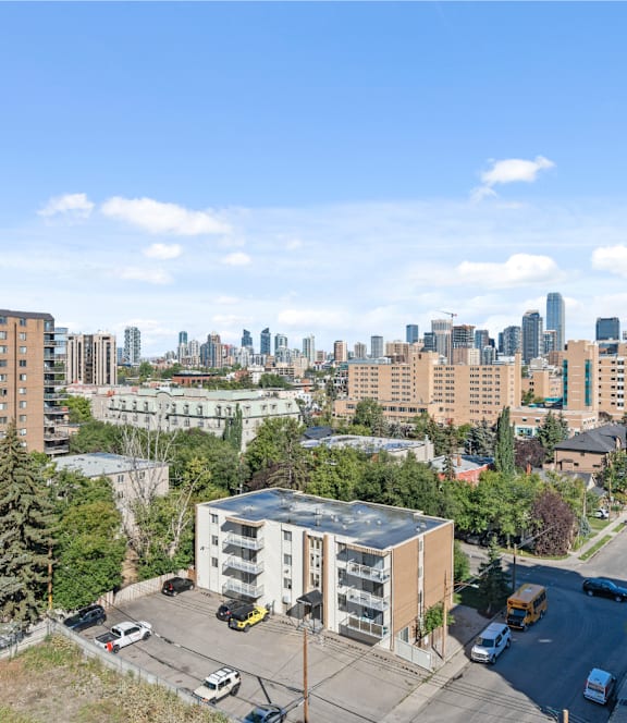 A cityscape with buildings and cars on the road.