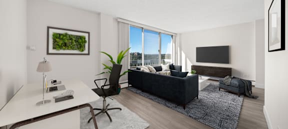 a living room with a black couch and a large window