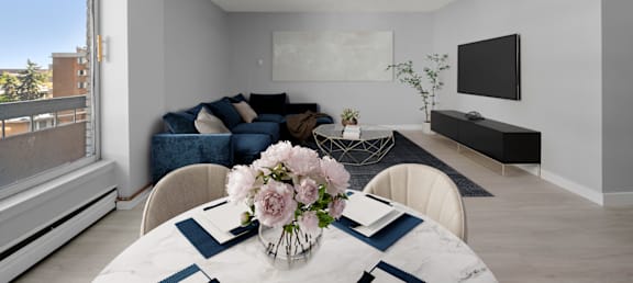 a living room with a table with a vase of flowers on it