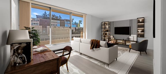 a living room with a white couch and a large window