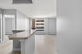 an empty living room with an island in the middle of it