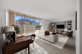 a living room with a white couch and a large window