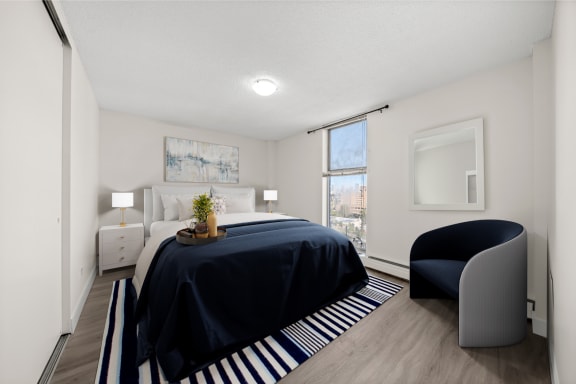 a bedroom with a large bed and a chair