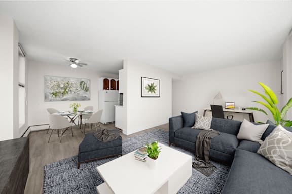 a living room with a gray couch and a white table