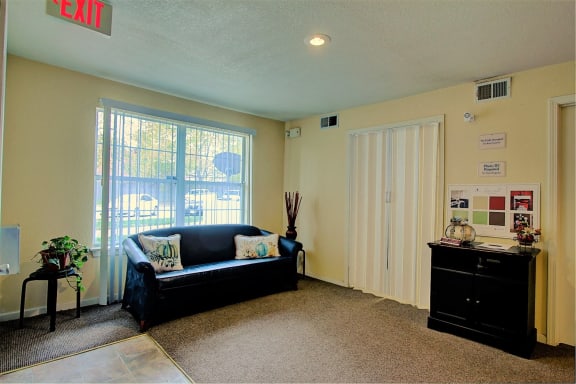 Image of carpeted room with furniture and window