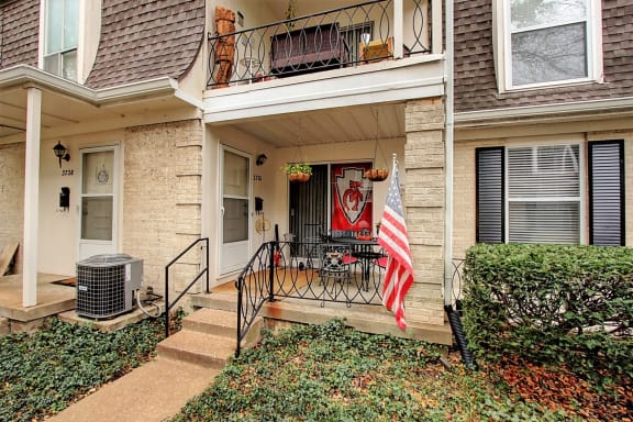 Exterior image of building with stairs and flag