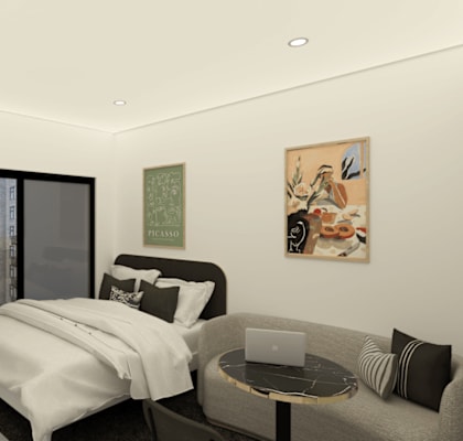 A bedroom with a bed, a couch, and a painting on the wall.