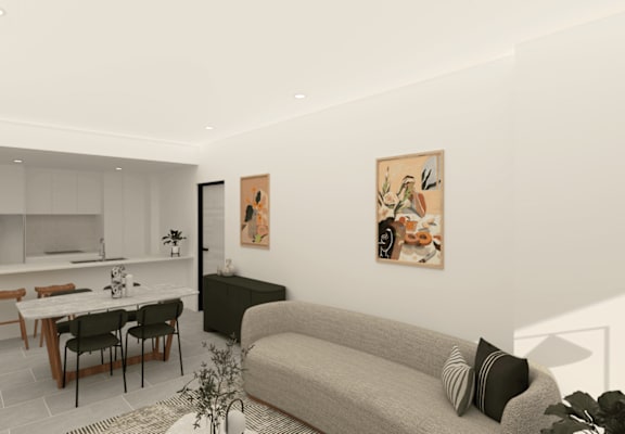 A modern living room with a grey couch and a dining table.