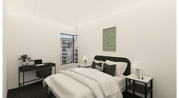 A bedroom with a large bed, a desk with a chair, and a framed picture on the wall.